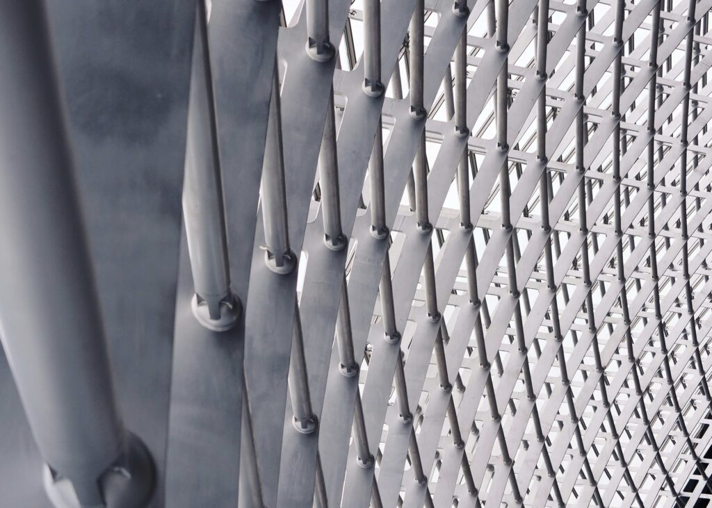 Professional steel fabricators and erectors working on a structural steel framework at a construction site.